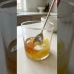 Close-up honey trick for men recipe in a glass with lemon and baking soda